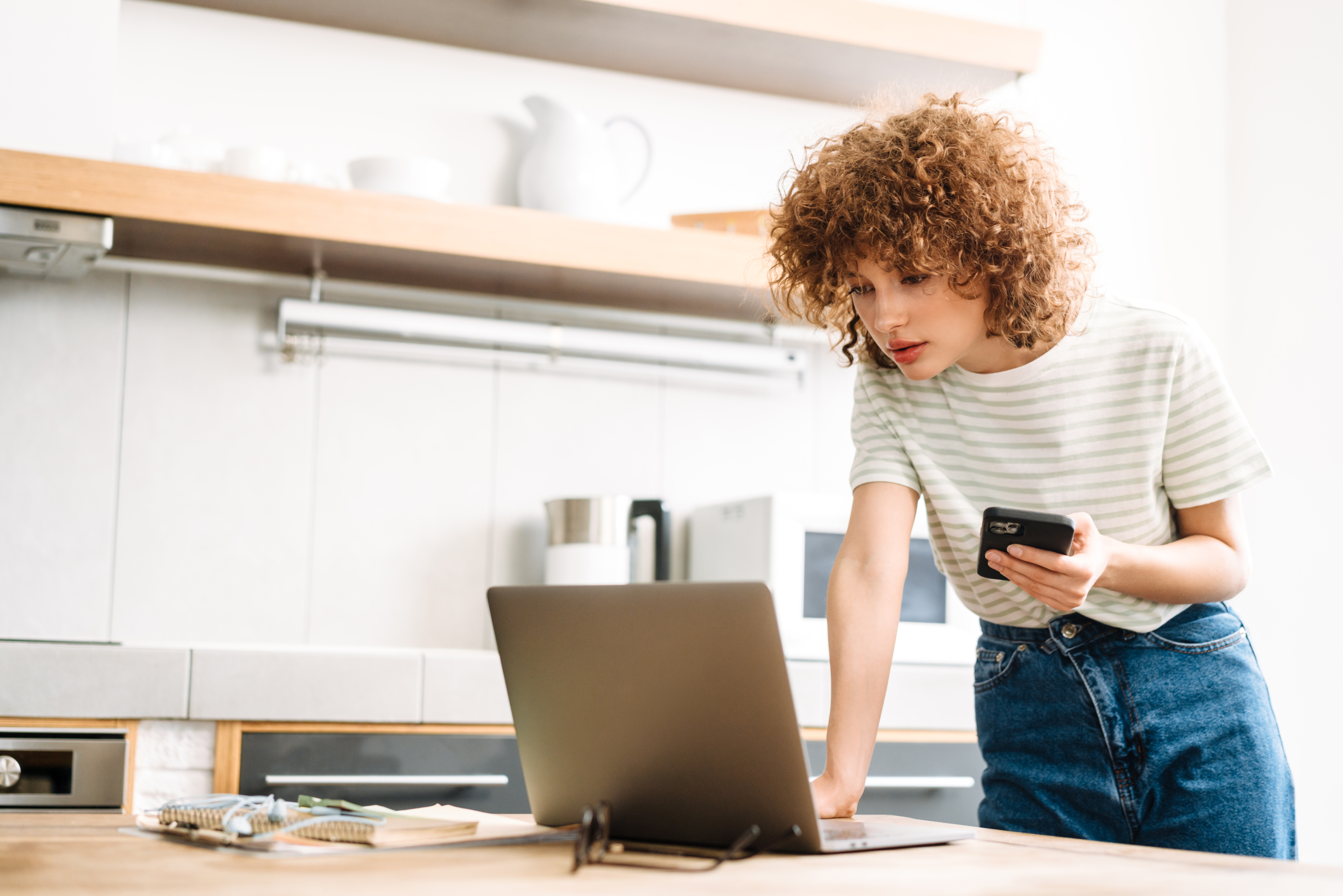 Woman using laptop and mobile 