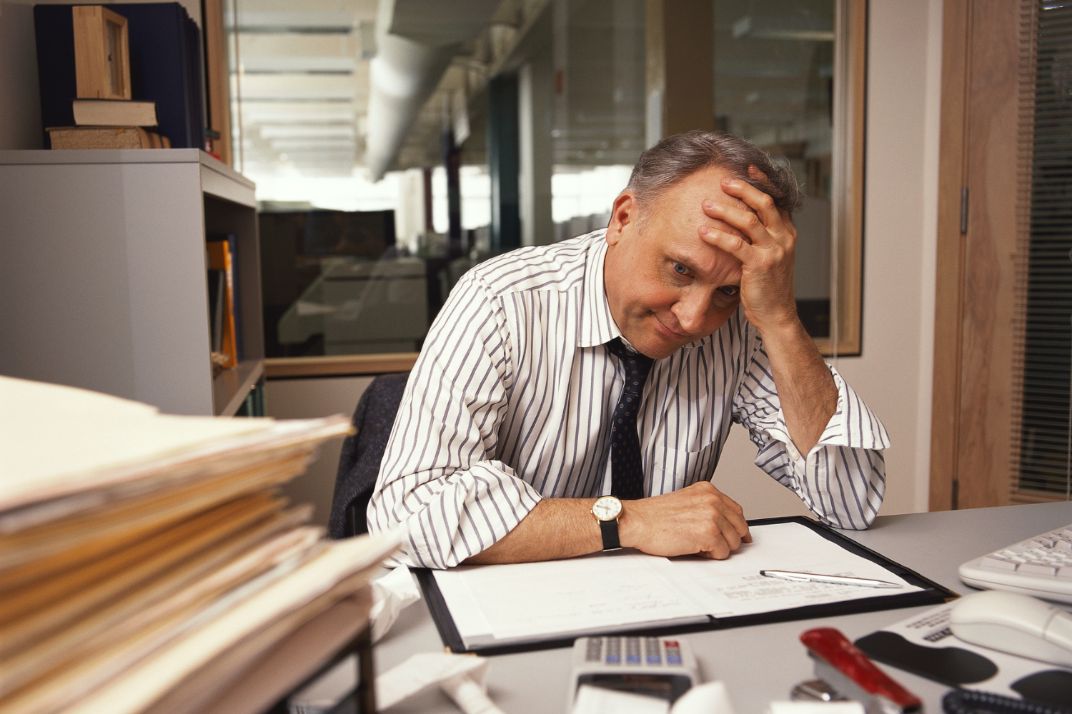A frustrated business owner at their desk.