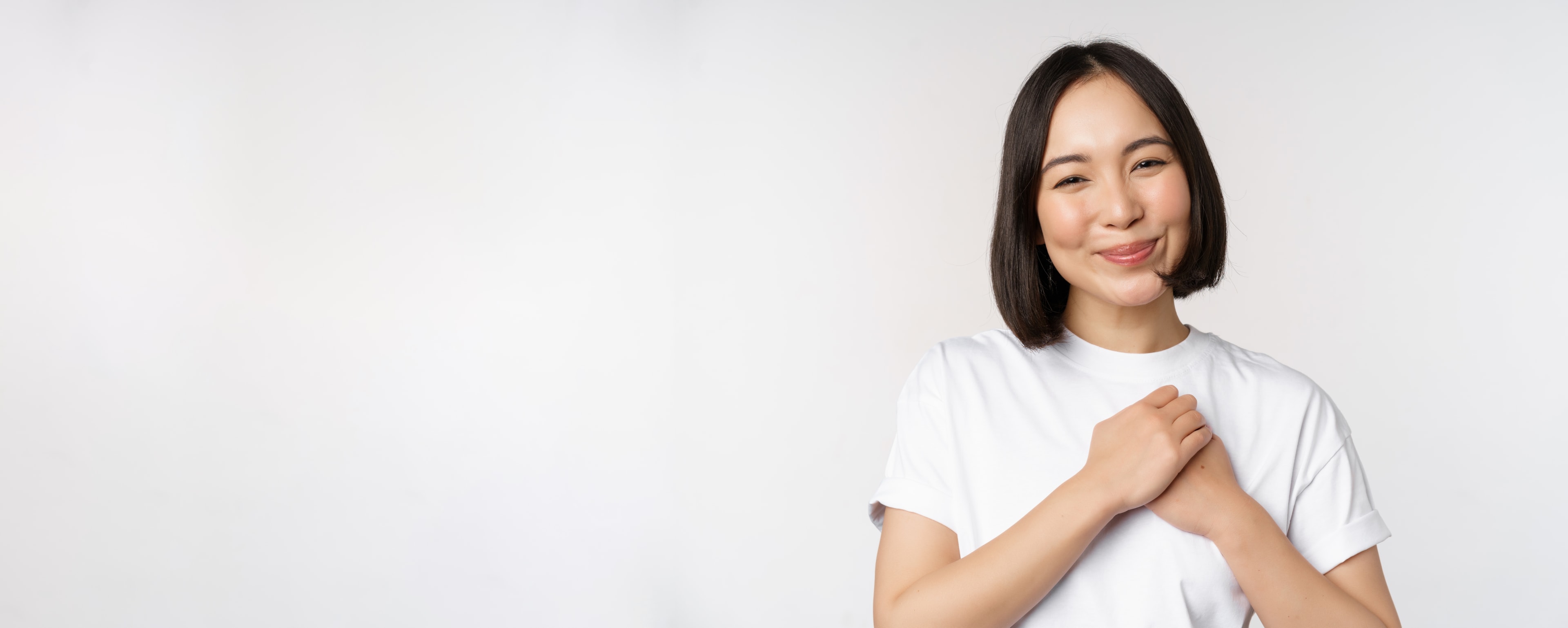 woman holding her hands in the chest feeling grateful