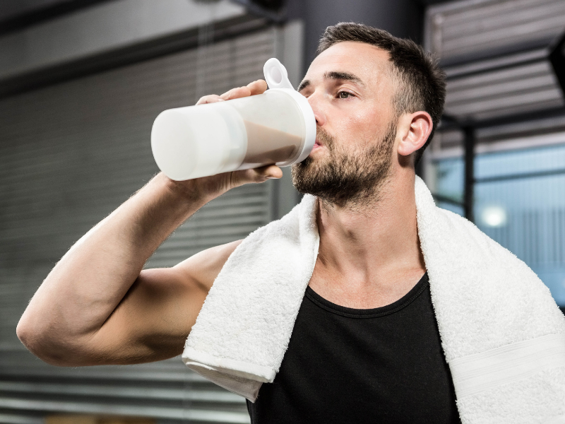 An athlete drinking high-quality protein powder after a workout.