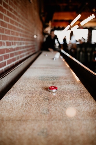 Shuffleboard is a common sight at dive bars located in Greenwich CT and nearby