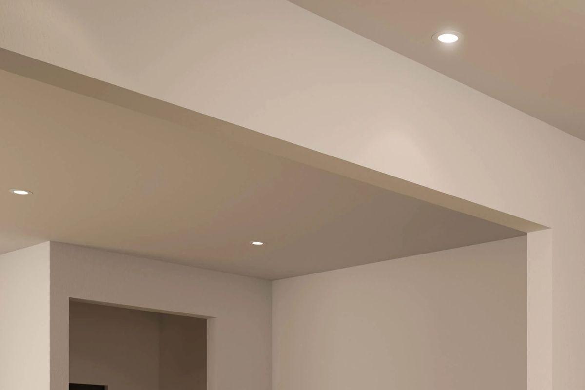 Minimalist interior with recessed lighting installed flush into a white ceiling