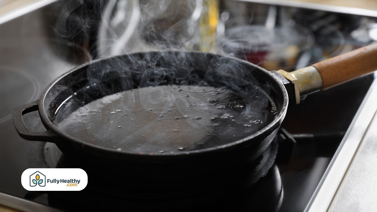 Overheated cooking oil smoking in black cast iron pan on stove