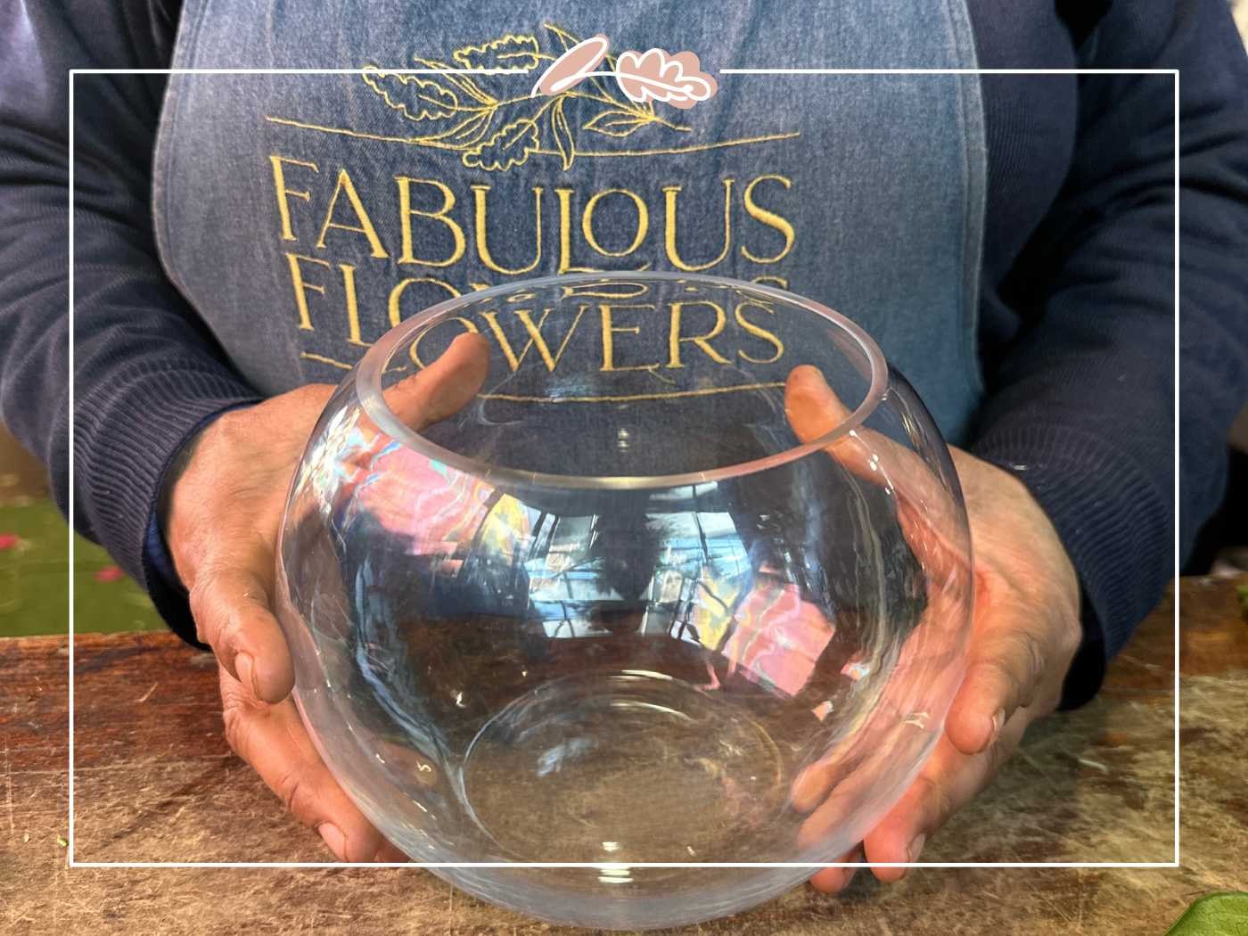 A florist holding a clear glass bowl, ready to be used for a floral display - Fabulous Flowers and Gifts