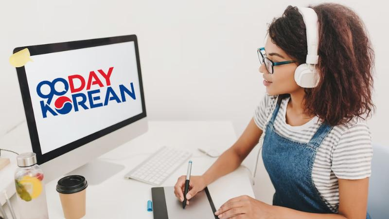 A female Korean language learner in front of her computer learning Korean from 90 Day Korean's website.