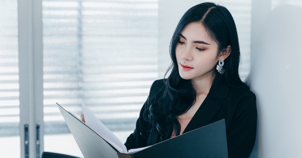 A woman reviewing a file about the 1099-MISC tax percentage.