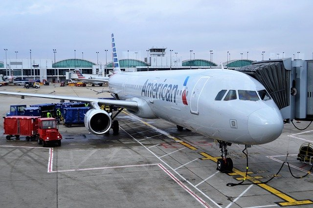 An airplane on the ground being loaded