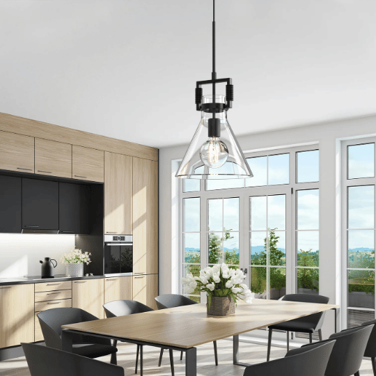 Modern kitchen and dining area with wooden cabinetry, black accents, a large wooden dining table, and a glass pendant light hanging above.