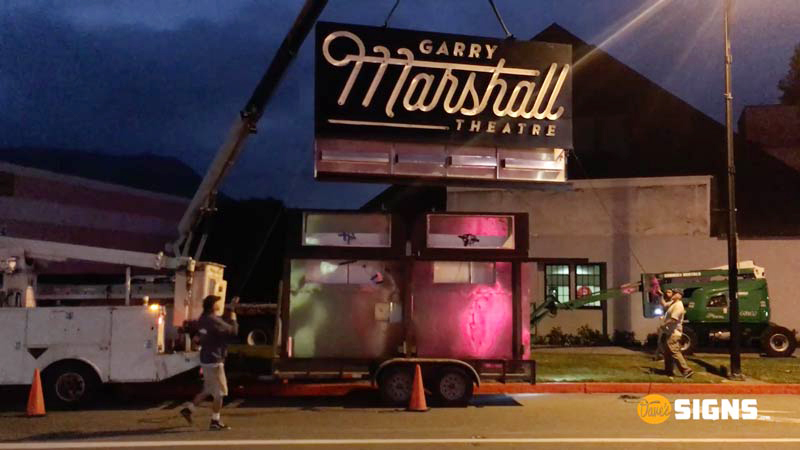 Installing the Gary Marshall Theatre sign in Burbank at night. Call Dave's Signs for your sign installation services.