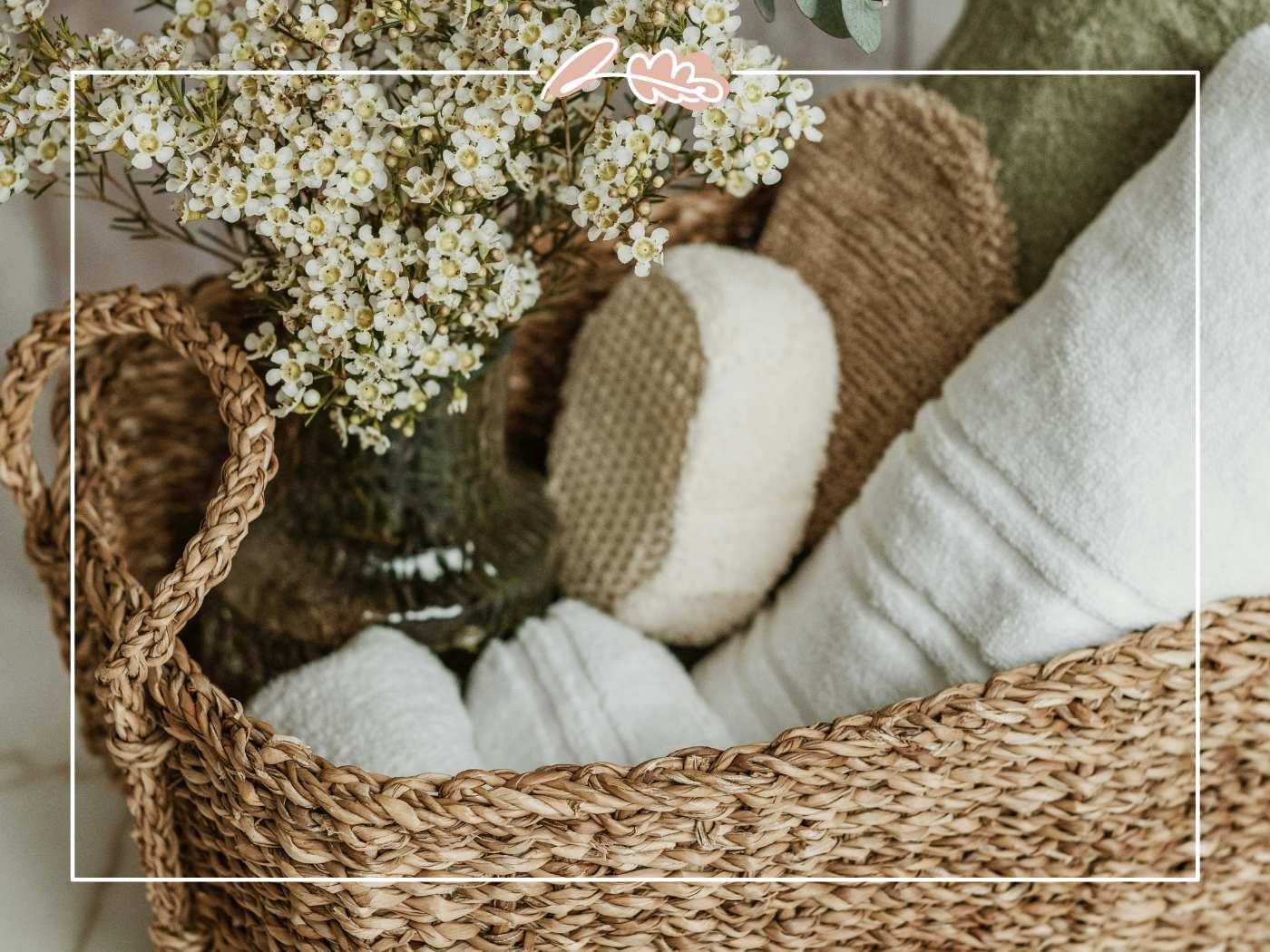 Woven gift basket or gift hamper with white flowers and spa items. A beautiful gift.