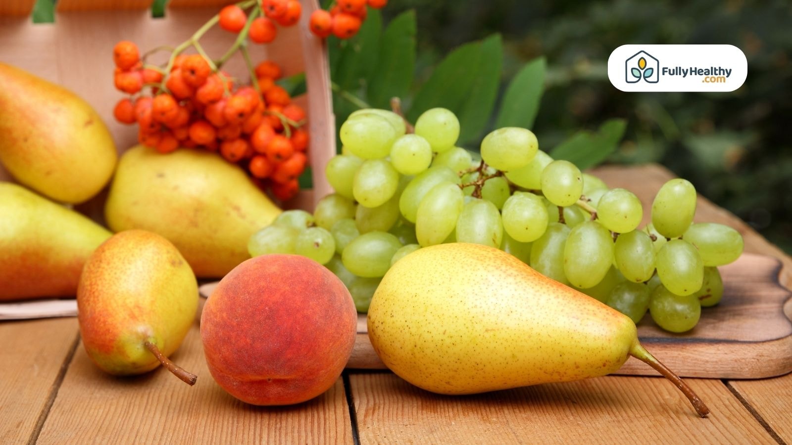 Mixed fresh fruits including apricots, pears, grapes, and berries displayed on a wooden surface