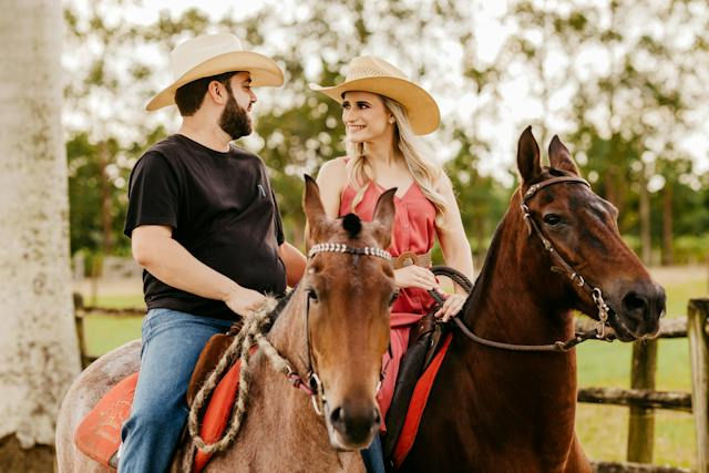 Couple horseback riding looking at each other