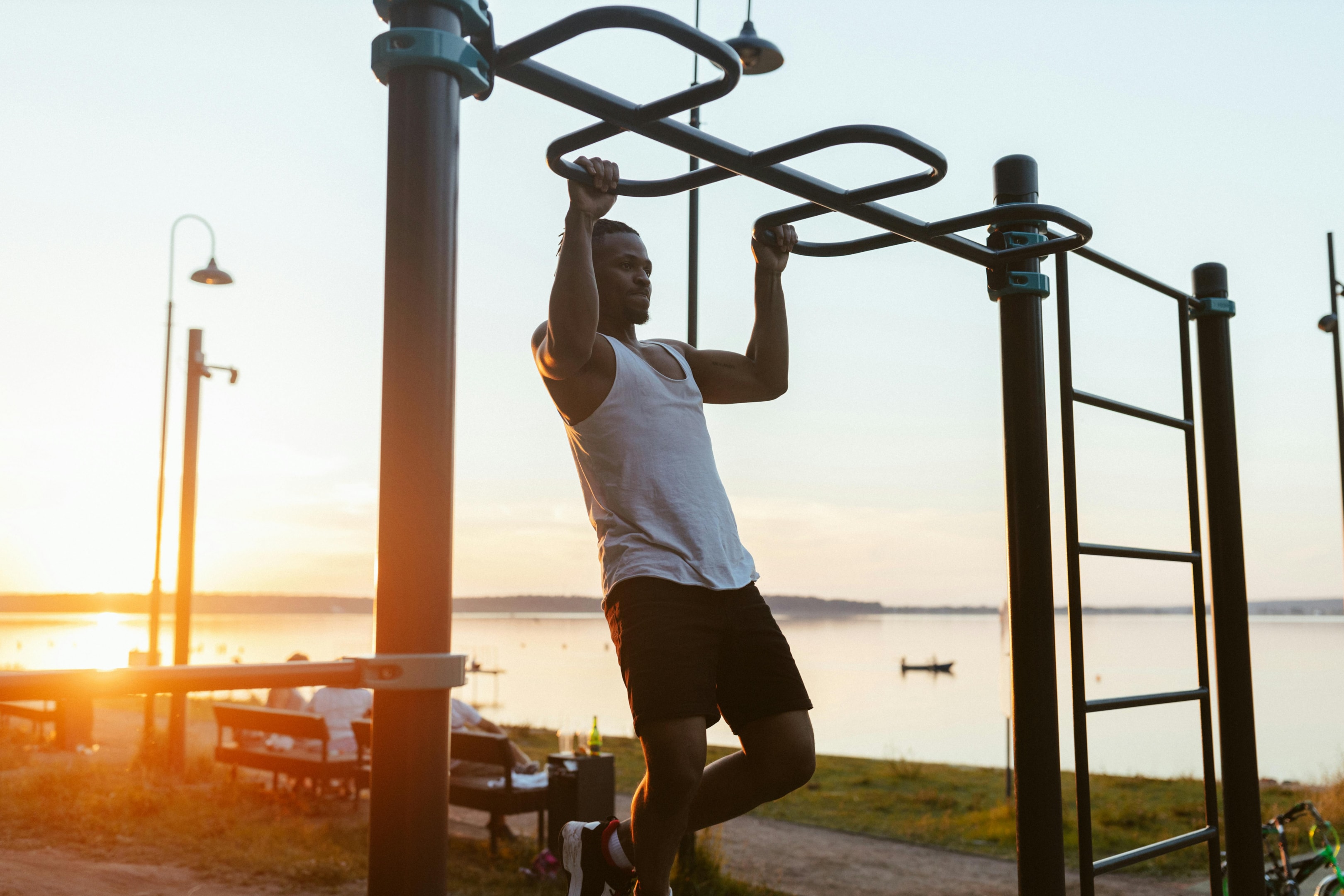 Photo by Yaroslav Shuraev: https://www.pexels.com/photo/man-in-white-tank-top-doing-pull-ups-8692269/