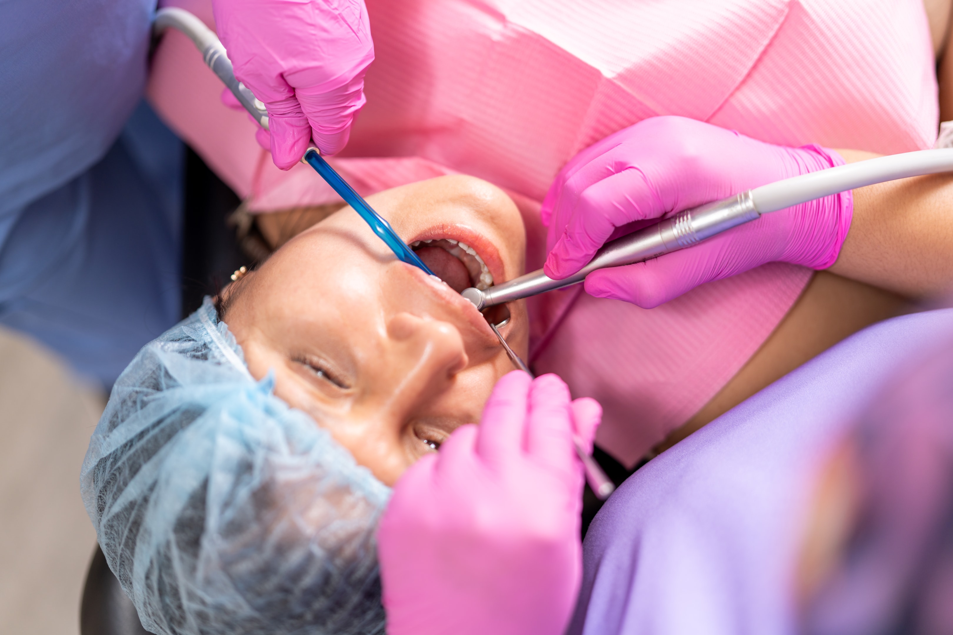 A photo of a woman doing dental procedure called wisdom tooth extraction.