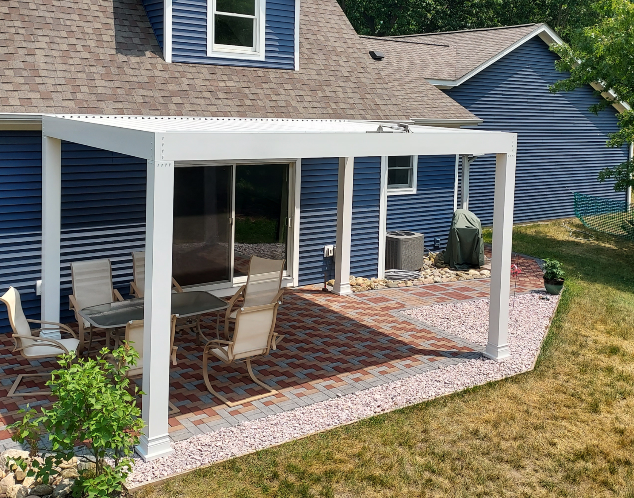 White aluminum pergola installed on a beautiful outdoor patio.