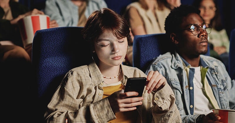 Woman watching a video on an airplane illustrating how content consumption habits influence competitive advantage.