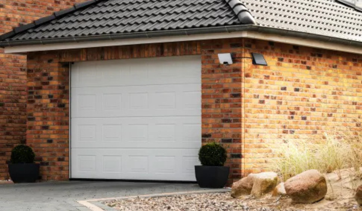 Home garage with flood light on driveway - detached solar panel on adjacent wall