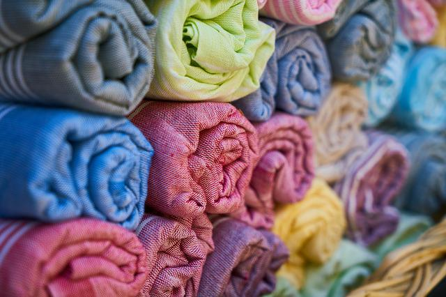 A stack of Pima cotton towels sorted by colors showcasing their textile fabric