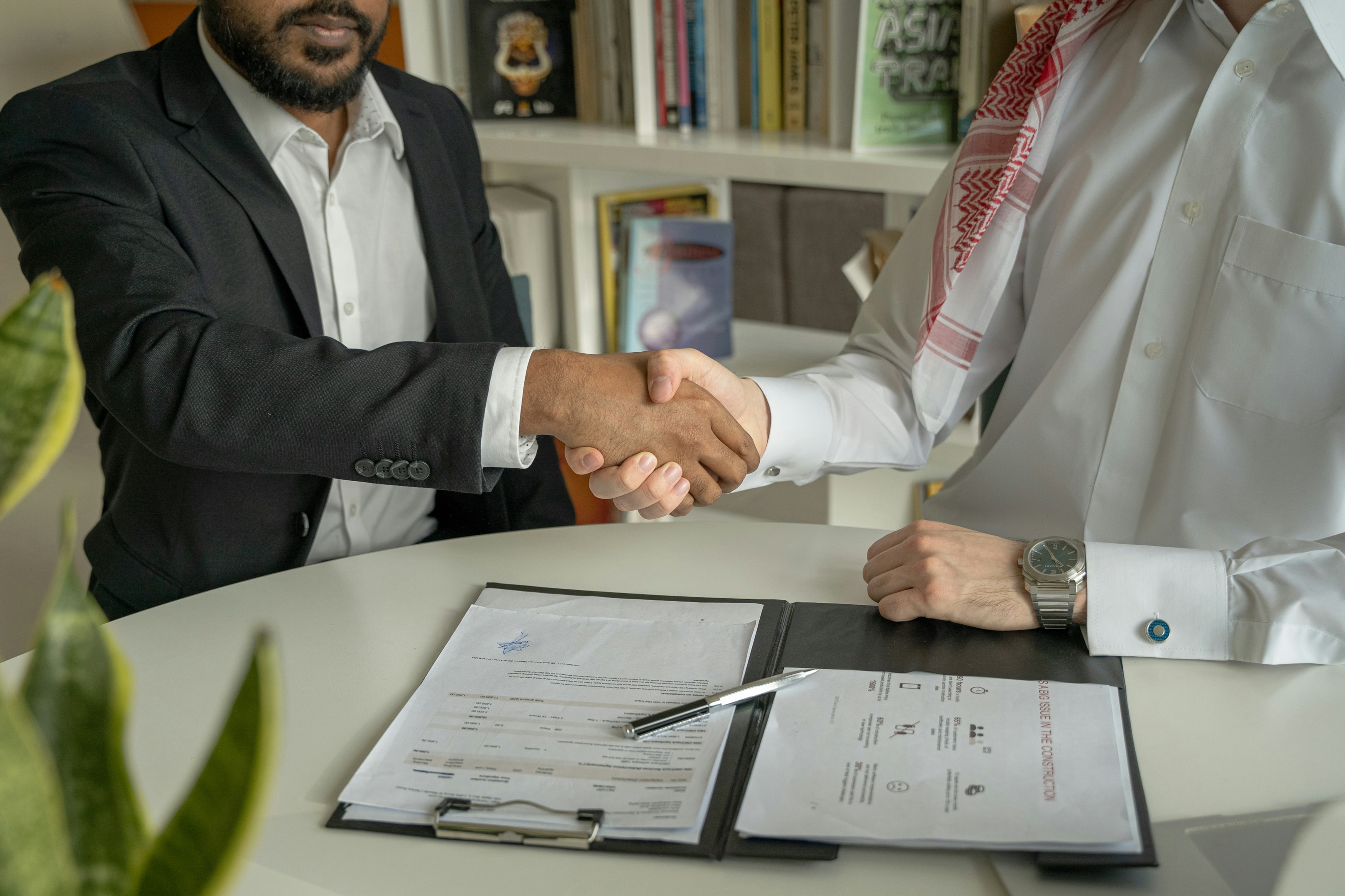 Real estate investor meets with bank officer to discuss funding options for new property.