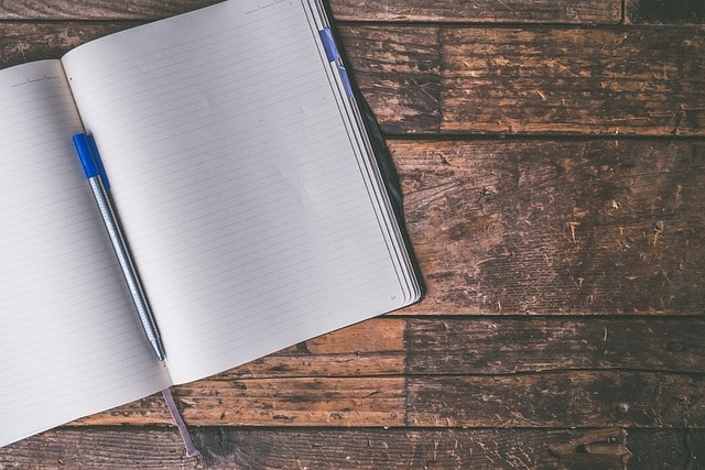 A blank notebook and a pen.