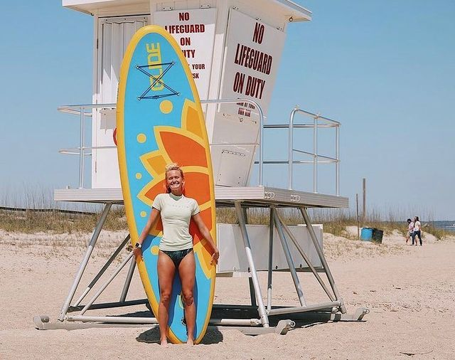 woman holding our paddle board