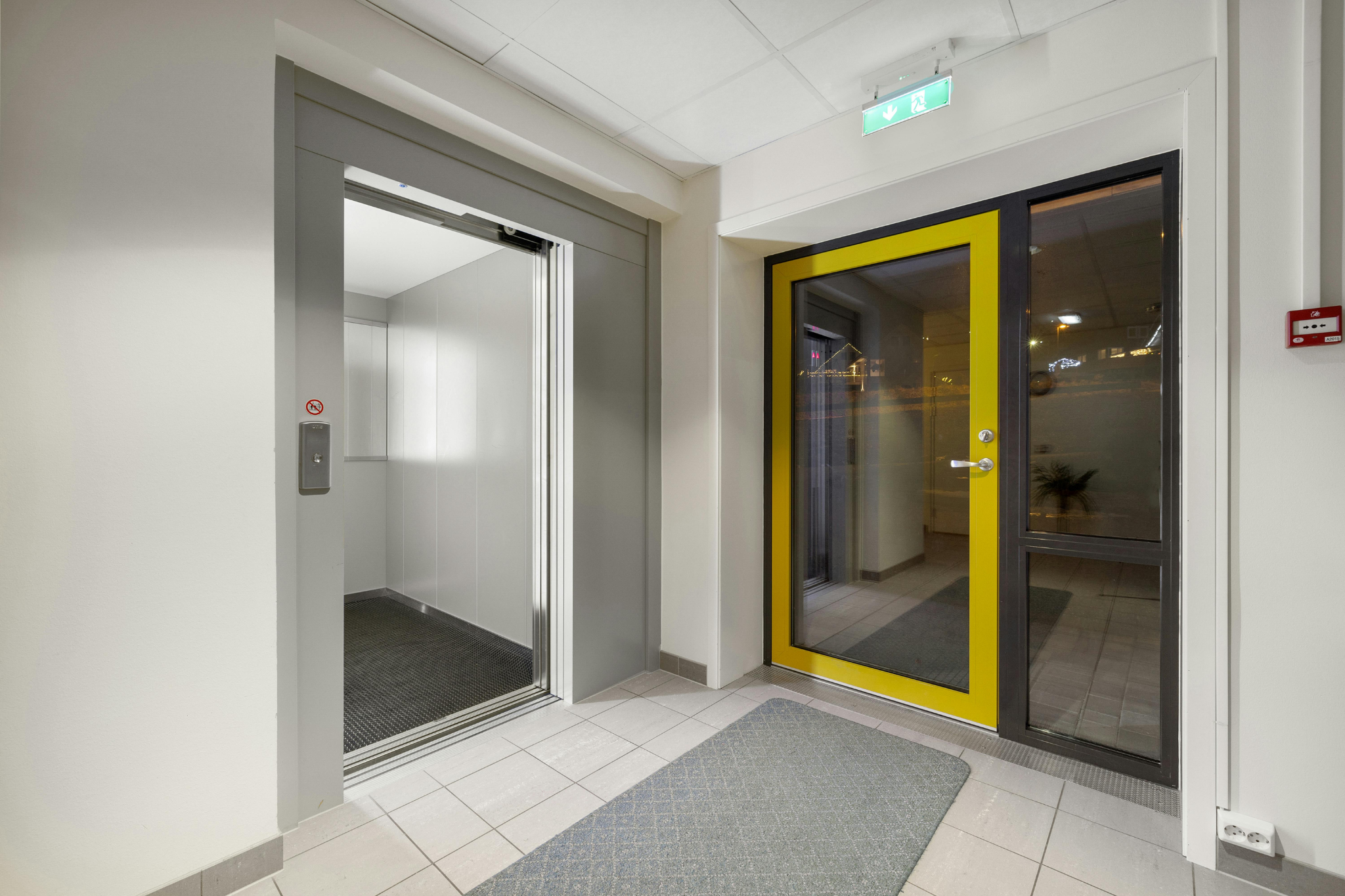 A residential platform lift by an entrance door.