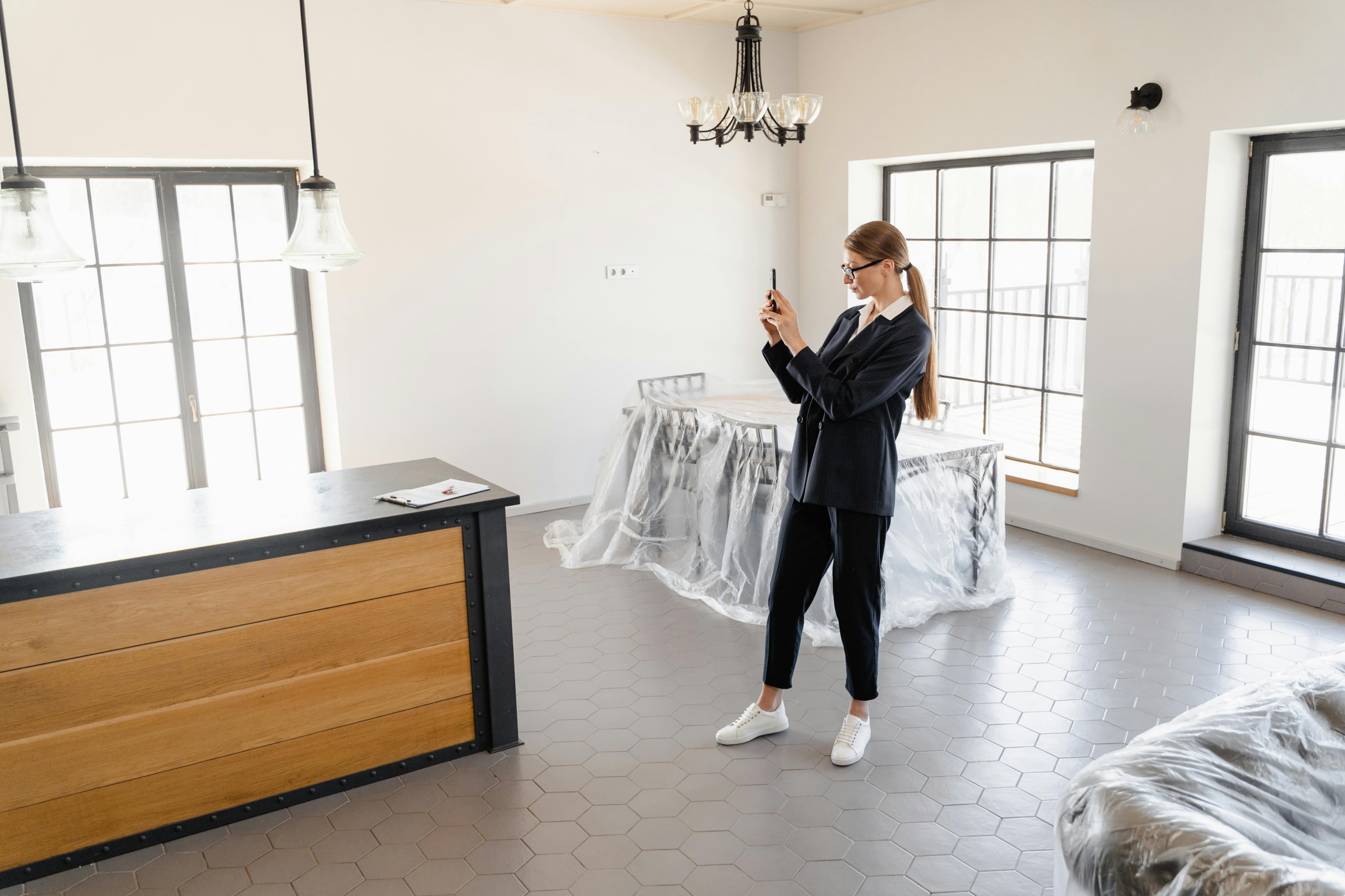 Real estate professional takes photos of property, to be used for digital marketing purposes.