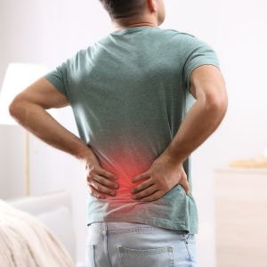 man with back pain needing chiropractic treatment