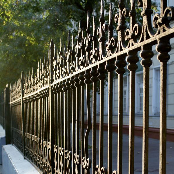 An image showing wrought iron fencing with decorative elements in a Phoenix garden.