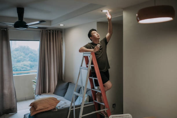 A person installing LED bulbs.