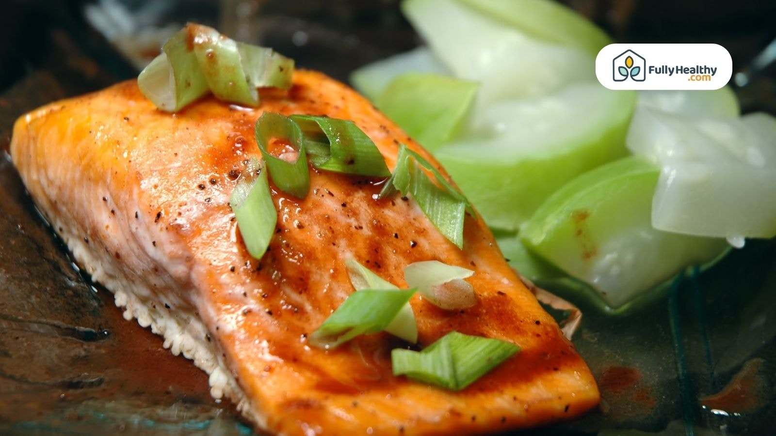 Grilled steelhead trout with green onions and cucumber slices on plate