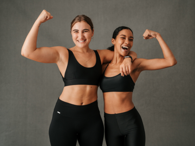 Two athletes showing improved upper body strength after weight training.