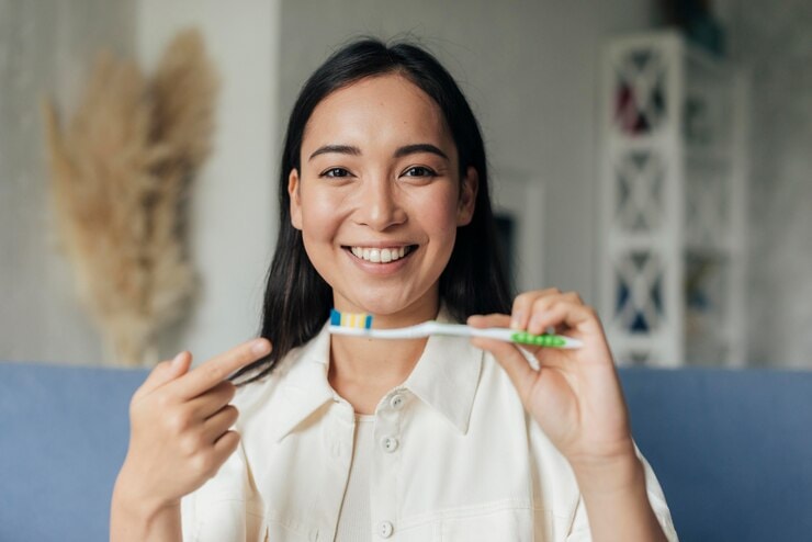 Woman pointing her toothbrush