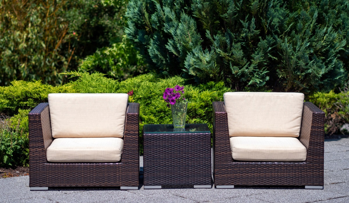 Rattan furniture-  two large chairs and smaller box table - wood frame - metal feet -dark natural rattan - cream outdoor cushions