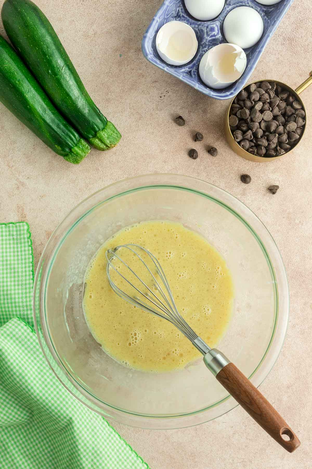 chocolate chip zucchini bread wet ingredients in large bowl with whisk