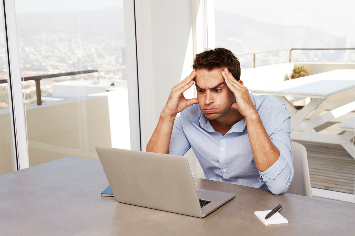 A confused startup founder on hid laptop.
