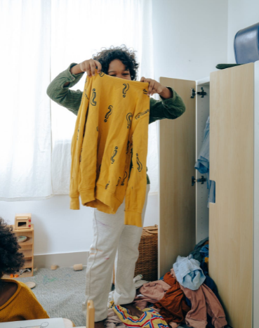 person organizing clothes in their room