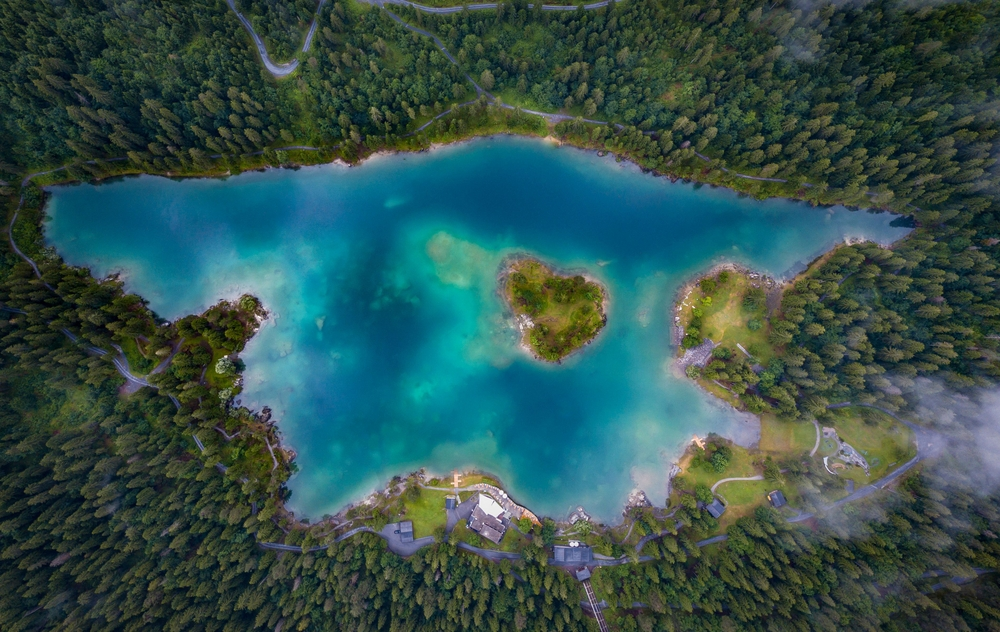 An aerial shot of Lake Caumasee showing it as a wooded island.  
