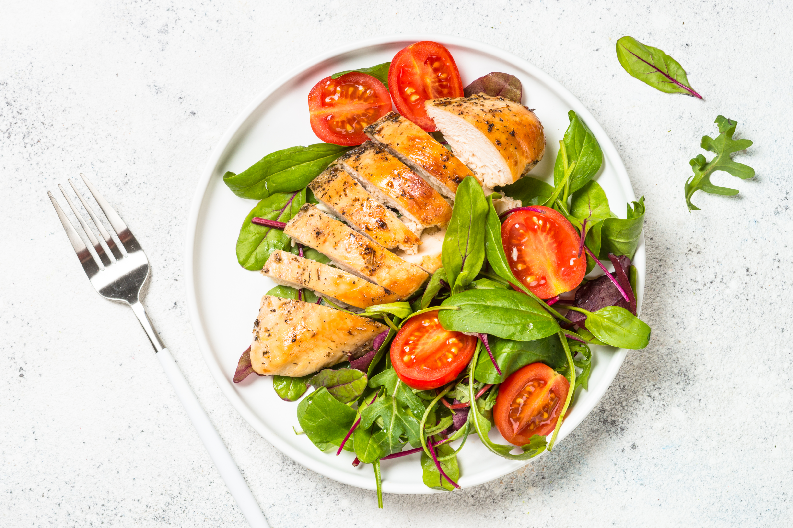 Grilled chicken breast with salad - lose weight by eating lean meats like chicken breast. 