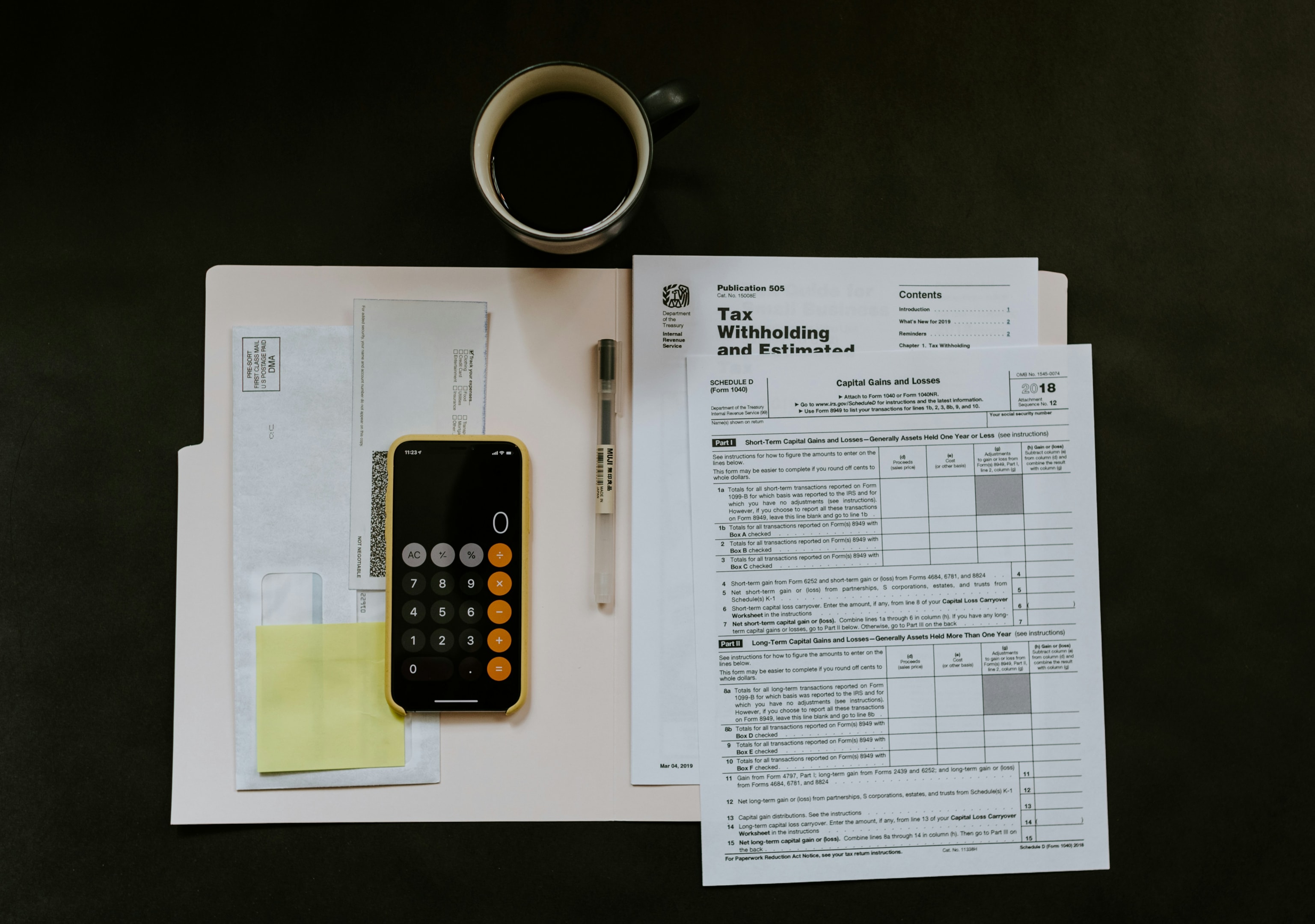 Tax paperwork and calculator used by real estate investor and their accountant during tax season.