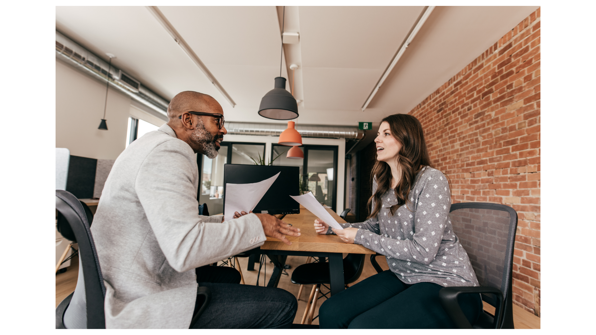 Two individuals discuss options in a business meeting.