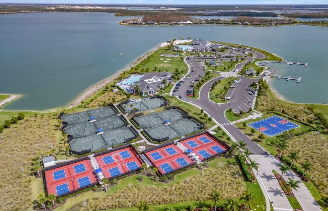 The image depicts scenic walking trails meandering through preserved natural areas, showcasing native Florida vegetation typical of the southwest Florida region. These trails offer residents of the master-planned community a chance to enjoy the lakefront lifestyle and connect with nature, all while being conveniently located near amenities like the Gulf Coast Town Center and Fort Myers.