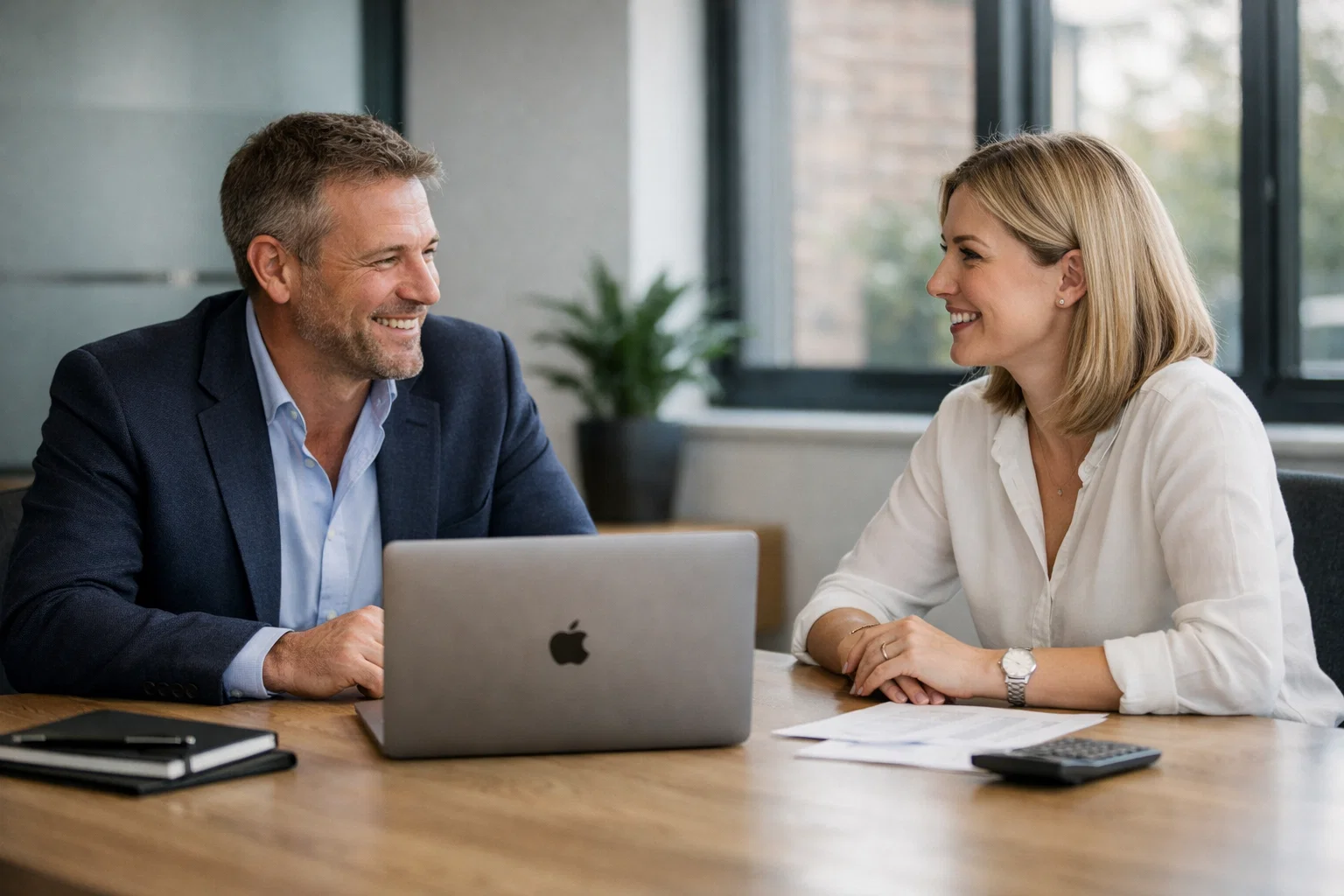 Business owner and accountant discussing the benefits of outsourced payroll services