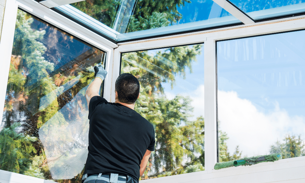 man fitting draft prevention to conservatory windows