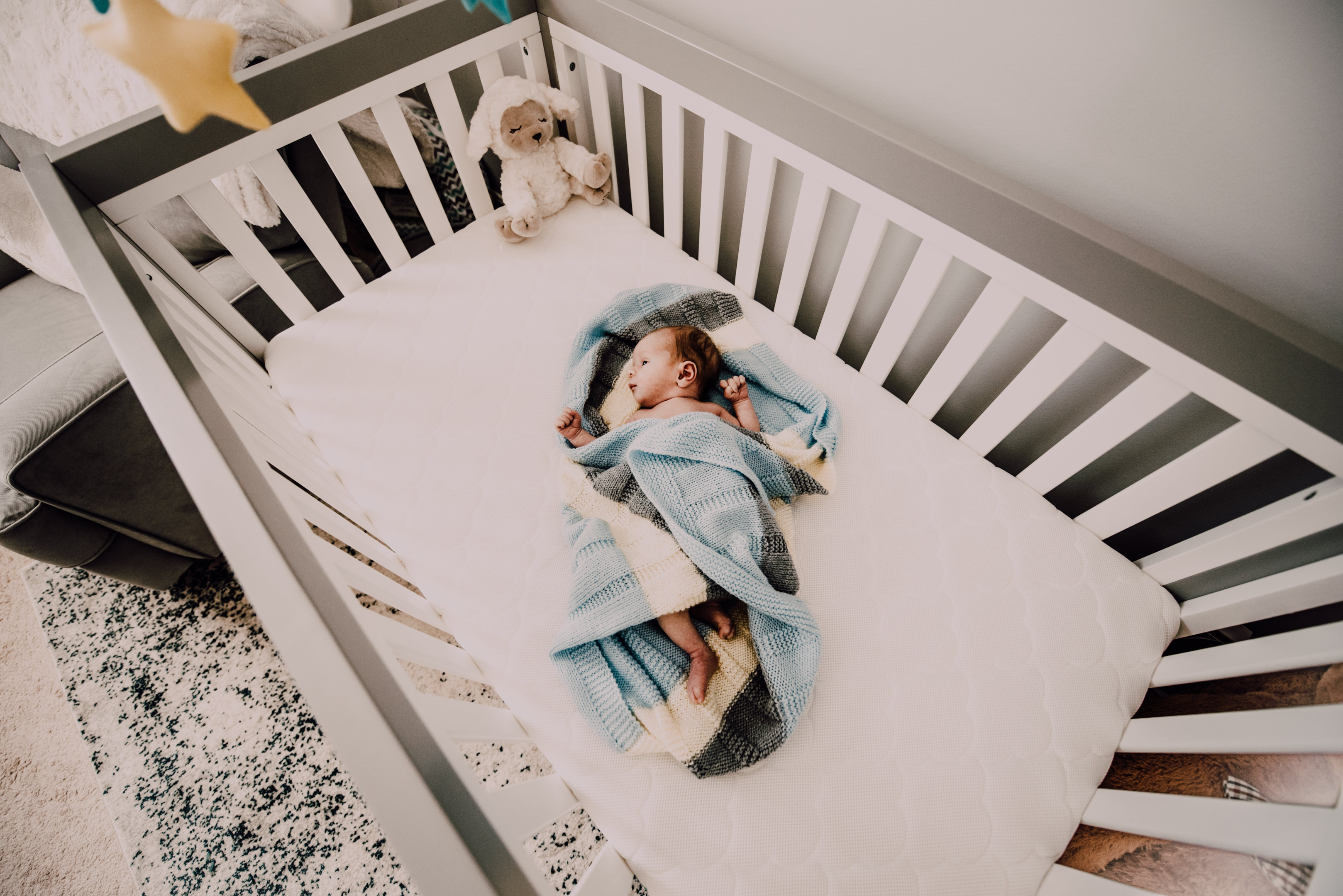 7 month old baby sleeping peacefully in crib