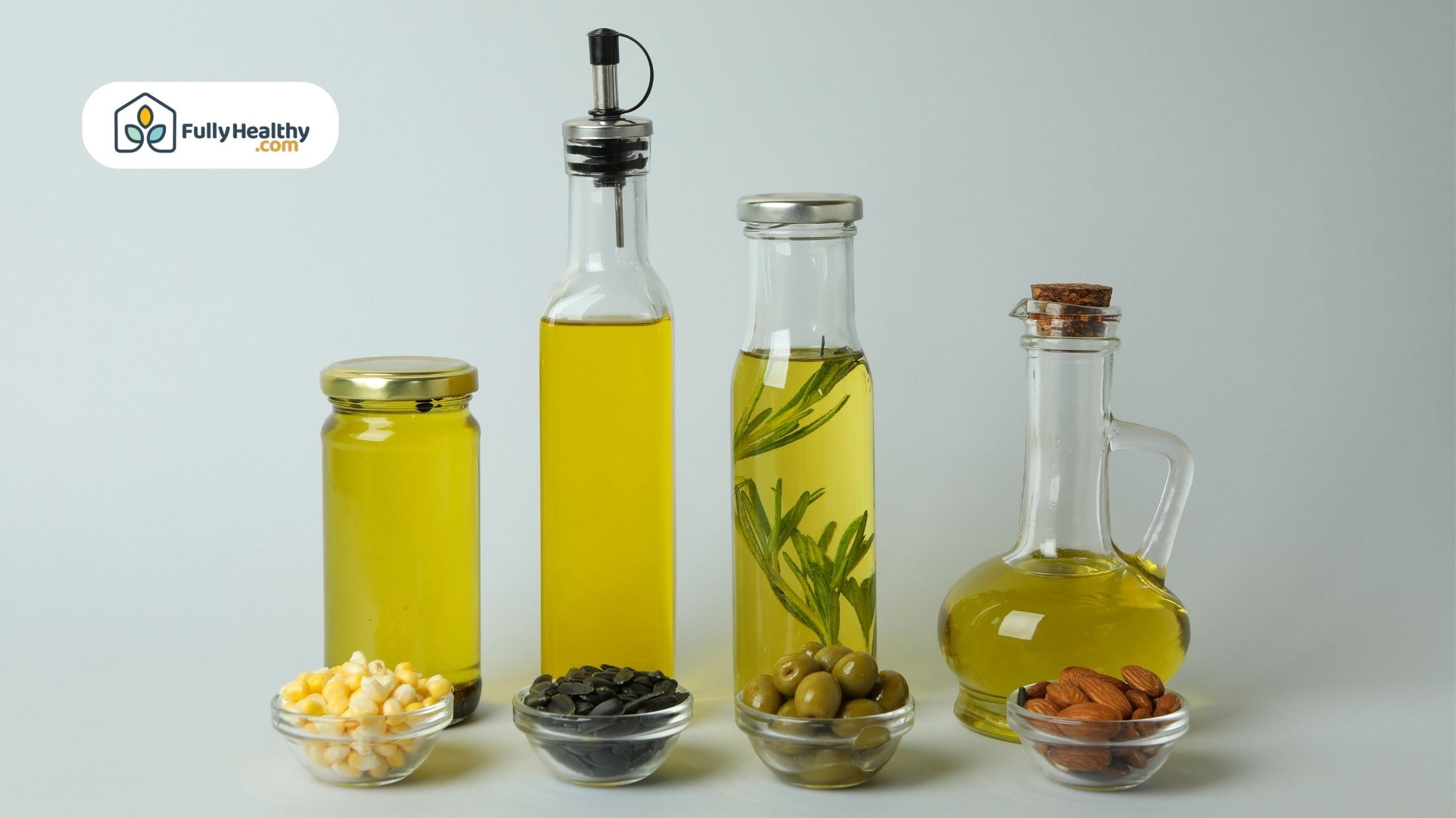 Different oils including infused olive oils, shown with fresh herbs, olives, and almonds in bottles