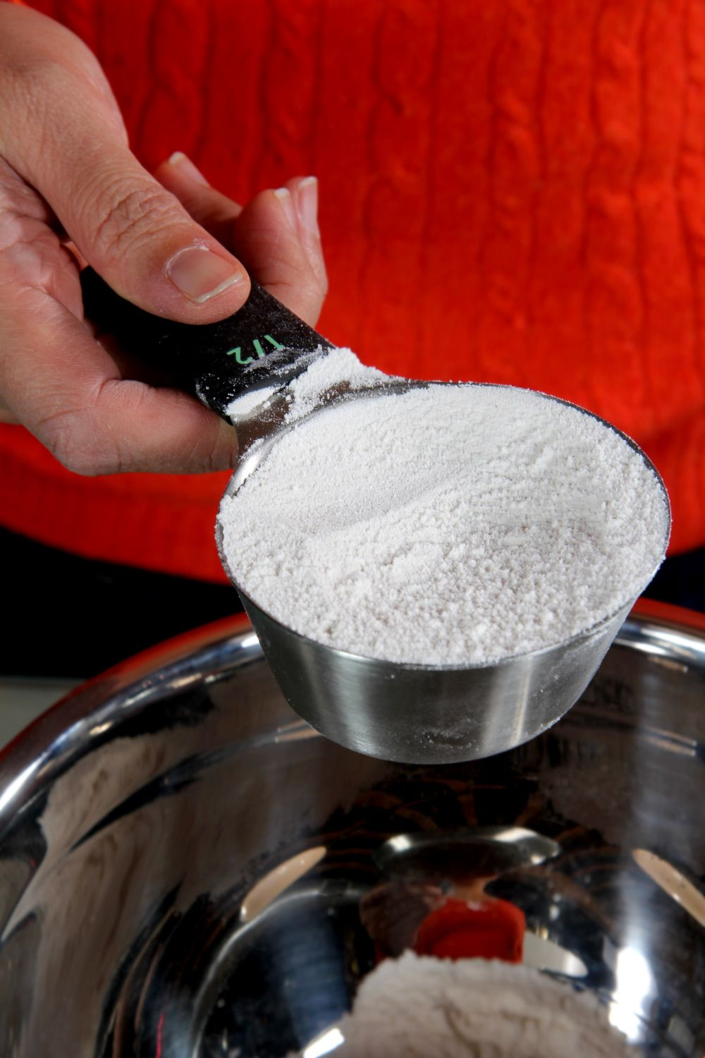 person holding a cup of flour