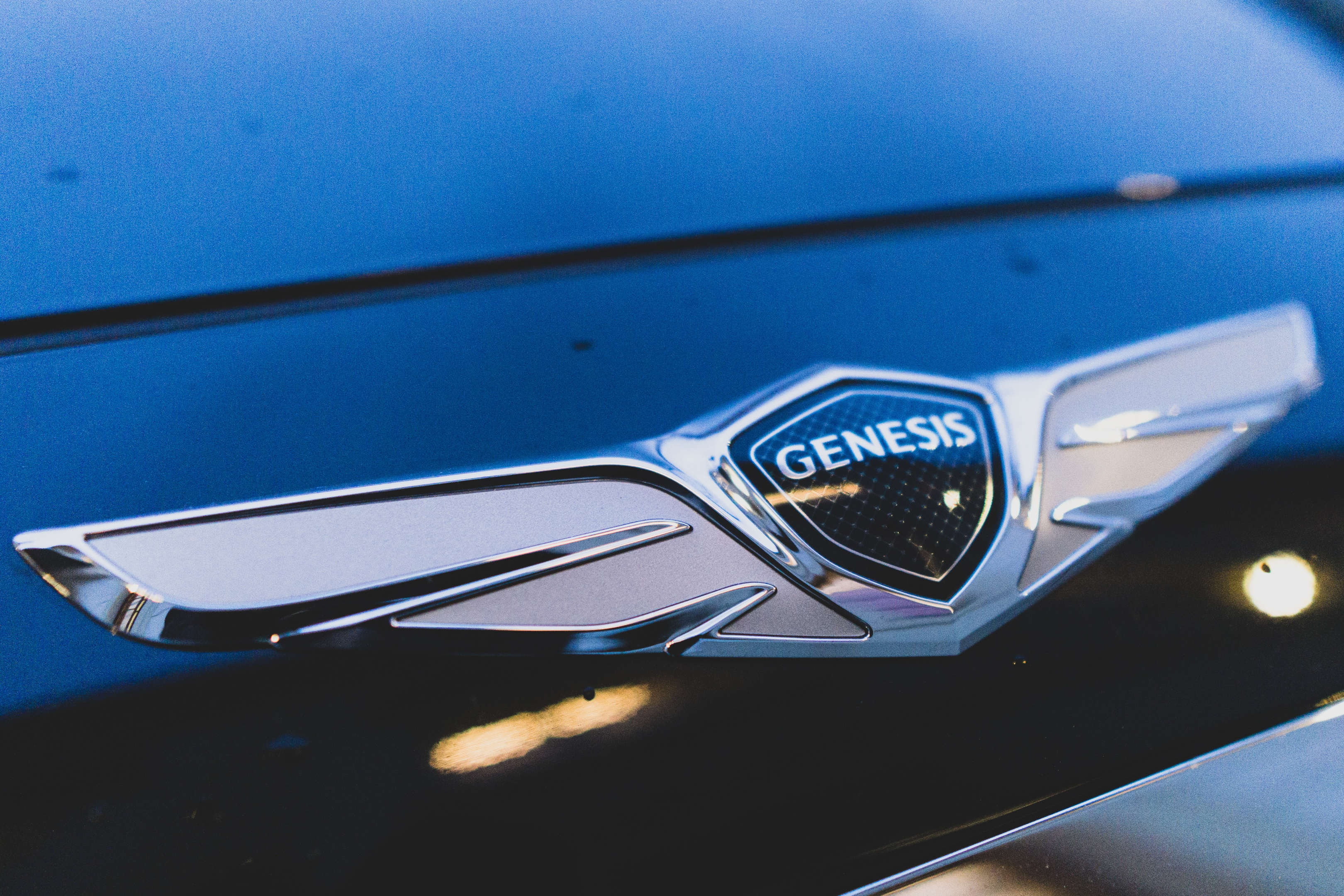 Genesis badge on car's front, close up