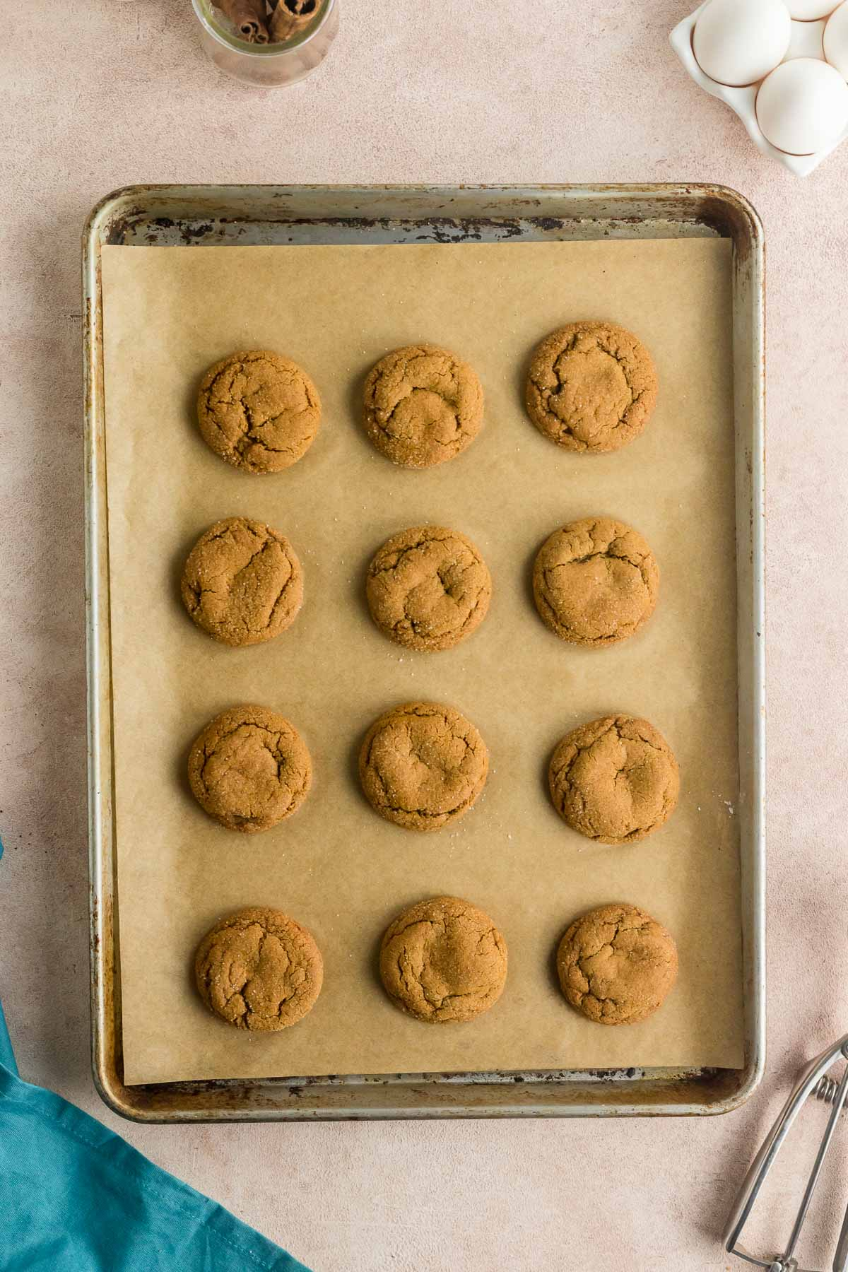 baked molasses cookies on parchment lined baking sheet