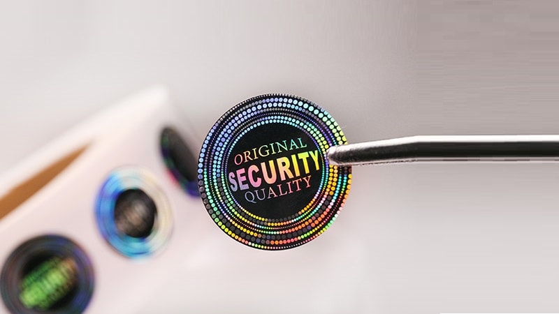 Rainbow-effect holographic sticker with 'ORIGINAL SECURITY QUALITY' text